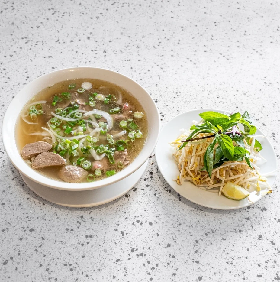 Bowl of beef pho with rice noodles and herbs at Saigon Royal Restaurant in Douglasdale Calgary